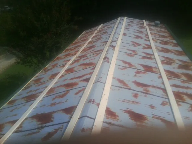 Rusted metal roof panels with new wood purlins before replacement — Storm Damage Roof Repair in Novato by Roofing Brothers