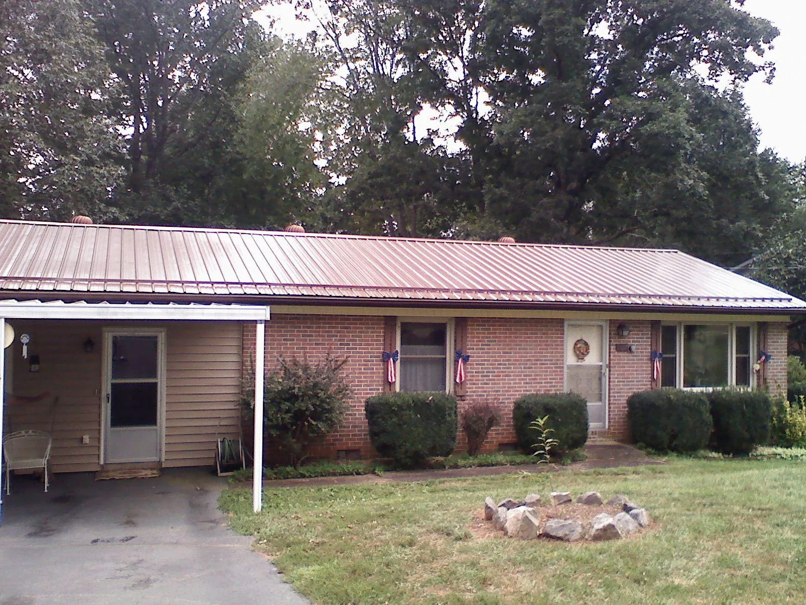 Bronze metal roof and carport on a brick ranch home — Roof Repair work by our crew in Novato